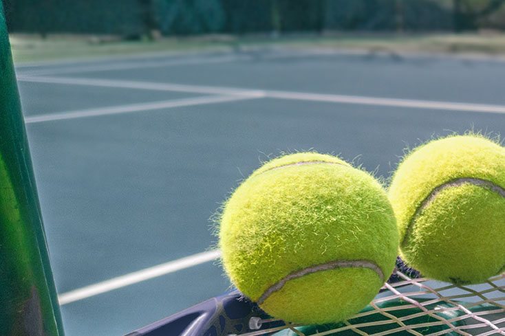 tennis balls on tennis racket