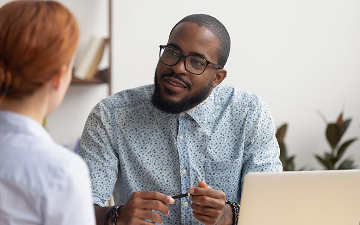 person speaking with boss at work