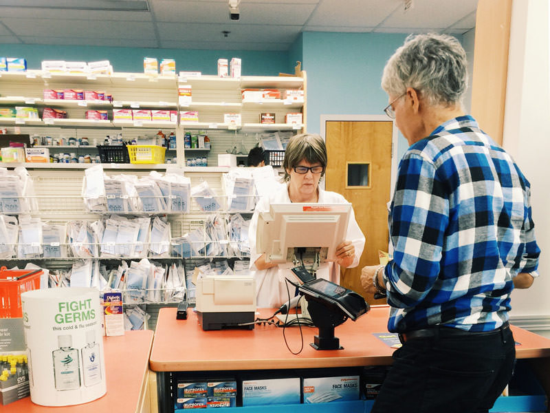 woman paying for medicine at pharmacy