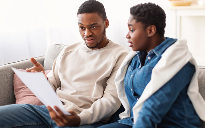 man and woman confused by medical bill