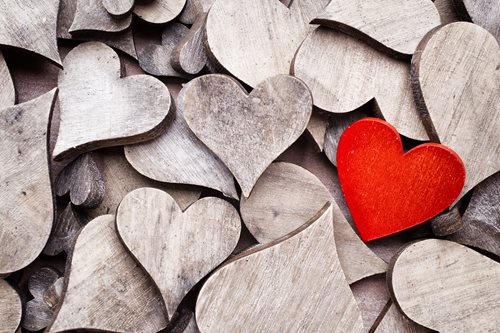 wooden hearts with one red heart