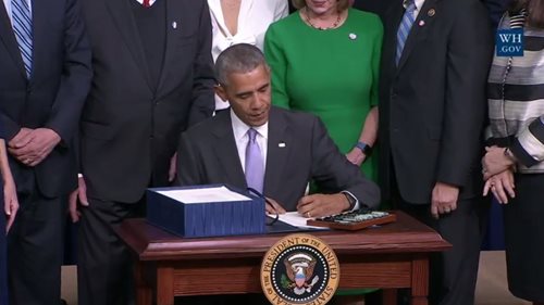 President Obama signing document