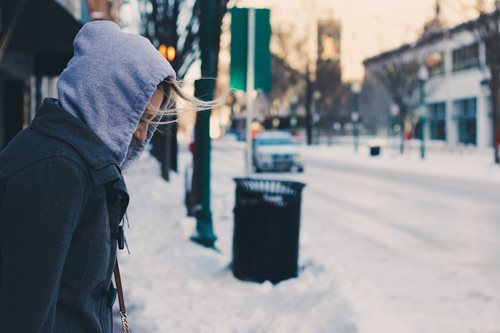person in a hoodie out on the street in the winter