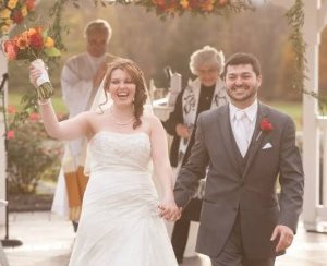 happy bride and groom coming down the aisle
