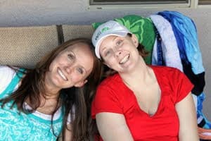 sisters sitting and smiling together