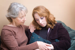 mother comforting daughter