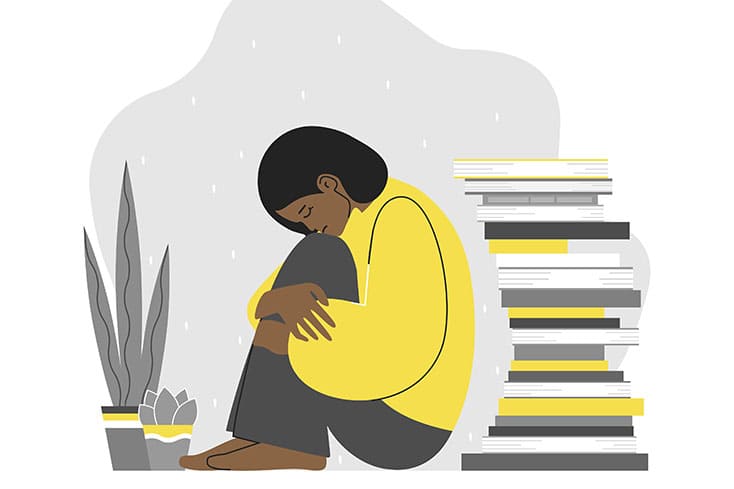 sad student hugging their knees