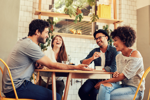 group of happy friends at a table