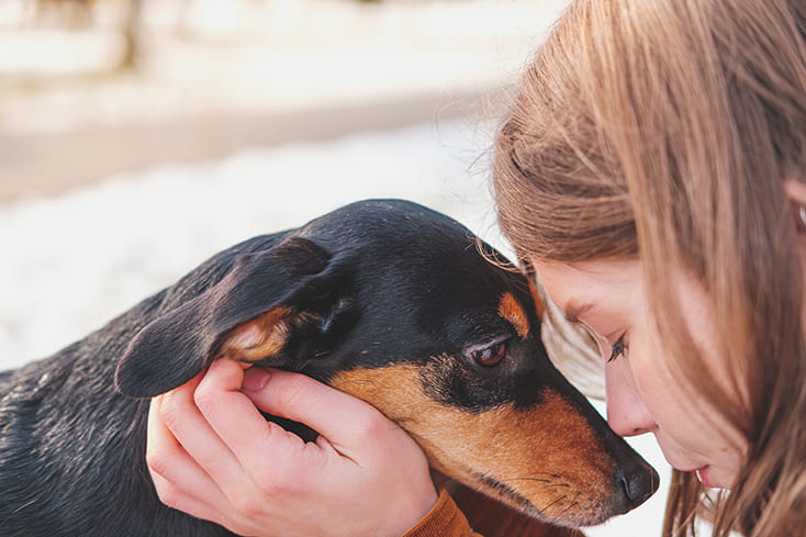 a woman face to face with her dog