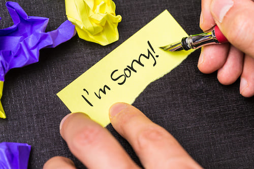 hand writing I'm Sorry on a scrap of paper