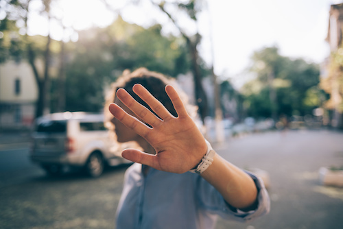 woman holding her hand up to the camera