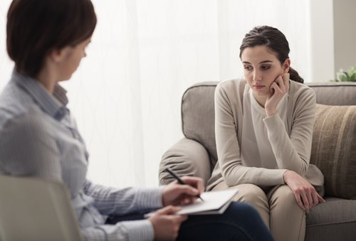 sad woman talking with a therapist