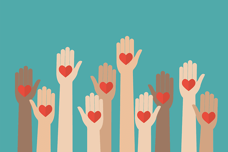 diverse hands raised holding hearts