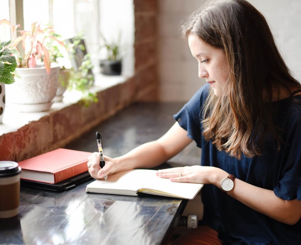 woman writing at a desk