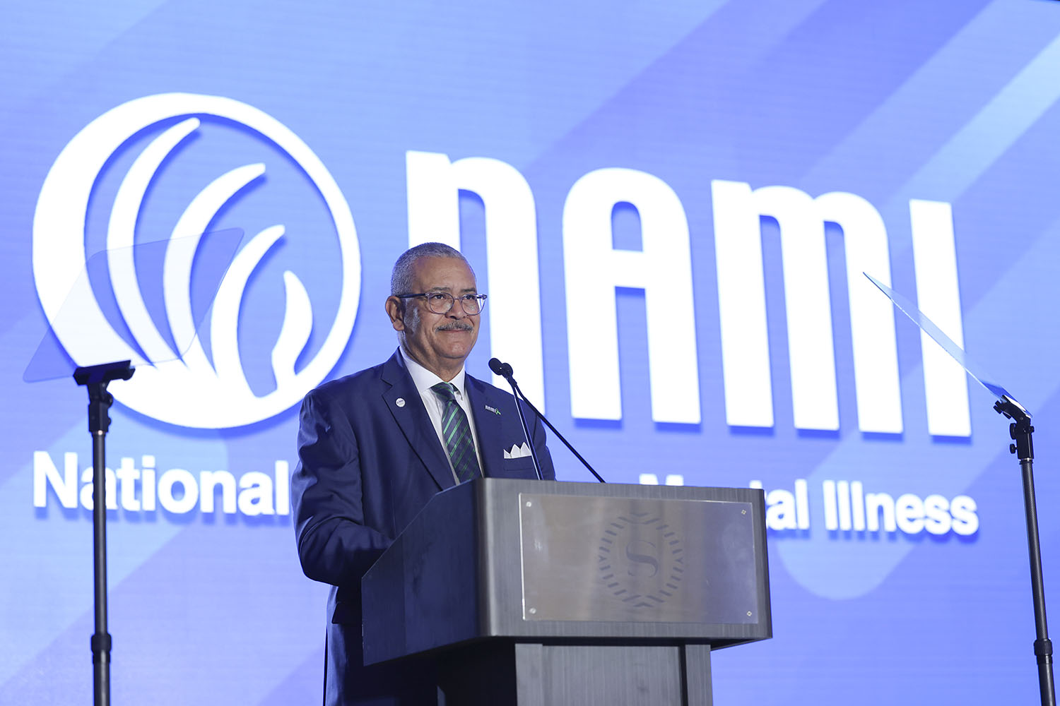 NAMI CEO Dan Gillison at a podium